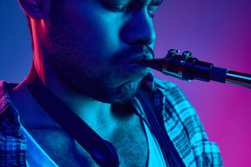 Close-up of man playing saxophone, jazz melodies against gradient pink-blue background vibrant...