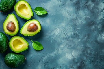 Many cut avocados on a dark surface, pattern seamless, flatlay layout. Concept of healthy food, diet with copyspace