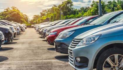 cars parked neatly in the parking lot in the afternoon with sunlight coming from outside