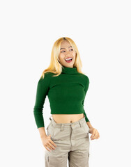 Young teenage college girl in green long sleeve t shirt posing smiling and looking camera isolated...