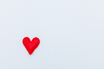 Frame from red felt hearts on white background. St. Valentine's Day concept. Top view, copy space
