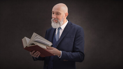 Portrait corporate d'un homme d'affaires de type avocat ou jusriste qui lit et consulte un livre
