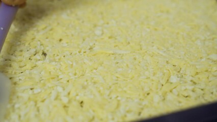 A man places a prepared vegetarian pizza base on a baking sheet. Cooking process, close-up.