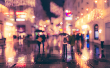 Crowd of anonymous people walking on busy vienna city street.night time