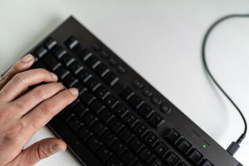 Left hand of a gamer on the keyboard. On the W, A, S and D keys
