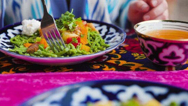 Shivit osh or Khorezm lagman green noodles Uzbek dish