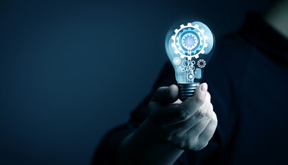 Creative thinking process. businessman holds a light bulb with gear icon. Meaning of excellent...