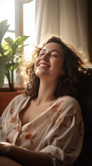 Fototapeta na wymiar A Happy woman sitting in comfortable chair in home design, relaxing, breathing fresh air. A smiling young female tenant or a tenant relaxing in an armchair relieves negative emotions