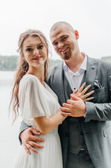 the bride and groom embrace