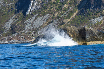 norway on the fjord, spray on rocks. Water splashes on the stones. Coastal landscape