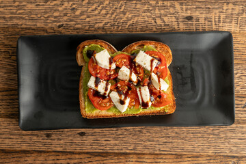 Avocado toast with tomatoes and mozzarella