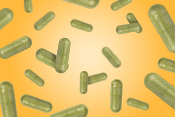 Vitamin. Capsules falling on orange gradient background