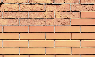 Fototapeta premium texture orange brick wall with damaged fragments