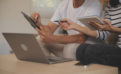 Naklejka premium Asian business people discussing team of young asian entrepreneurs discussing business, Asia business team meeting discussion talking.