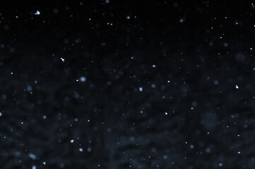 Bokeh of white snow on a square shape gray background. Falling snowflakes on night sky background, isolated for post production and overlay in graphic editor.