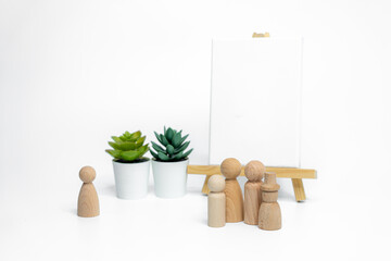 Wooden doll with empty easel on white background; business or creative concept