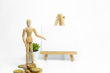 Wooden doll with empty easel on white background; business or creative concept