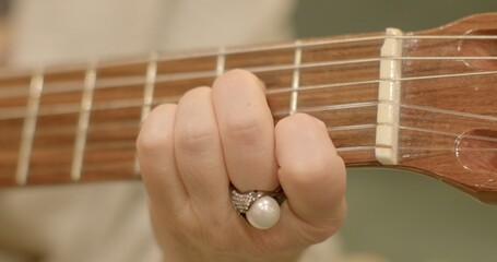 Playing the guitar close-up. Memory Enhancement: Playing music involves memorization of chords and...