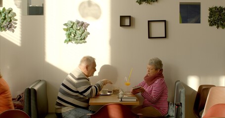 Couple in cafe. An elderly man engages in effective communication through nonviolent communication,...