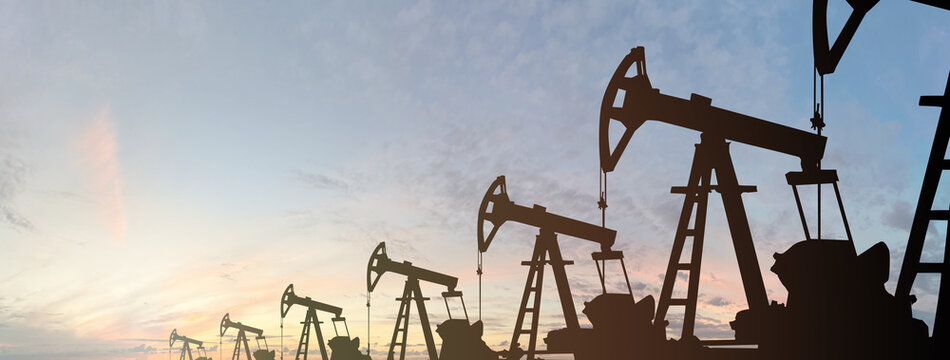 Black pump jack silhouette. Oil and gas industry equipment against sunset sky clouds background - Powered by Adobe