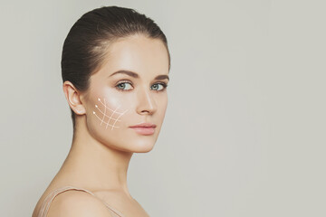  Elegant woman. Face lift anti-aging lines on young female face. Graphic lines showing facial...