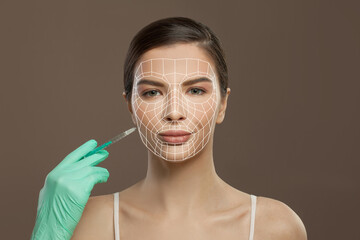 Perfect woman with arrow lines on her face for lifting skin and syringe in medical hand. Medicine, injection and anti-aging concept