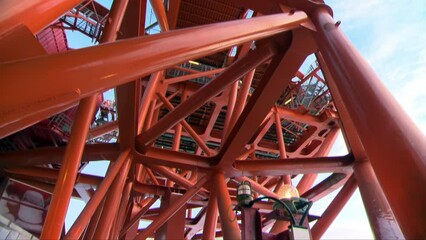 Panorama up the metal deck structures of an offshore oil production platform.