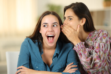 Woman telling amazing secret to a friend