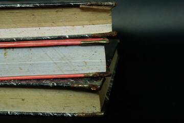 Arrangement of old books. Old books piled up in a heap, close-up, learning and education concept.
