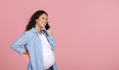 Happy young pregnant woman have phone conversation