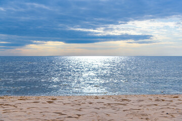 Mystical seascape - the shore of Lake Onega with rolling waves against the background of clouds at...
