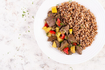 Buckwheat porridge with chicken liver, sweet pepper and apple. Dinner. Diet menu. Top view