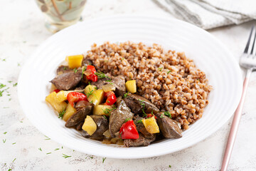 Buckwheat porridge with chicken liver, sweet pepper and apple. Dinner. Diet menu.