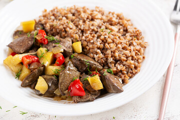 Buckwheat porridge with chicken liver, sweet pepper and apple. Dinner. Diet menu.