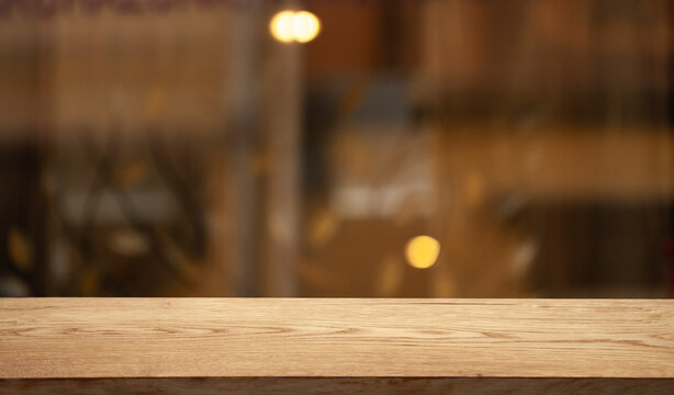 dark blurred background with empty table top, cafe restaurant windows. background for your product