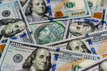 A 100 zl Polish banknote surrounded with 100 USD banknotes