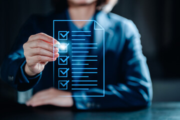 Businesswomen evaluate the performance of business via checklist systems online, take...