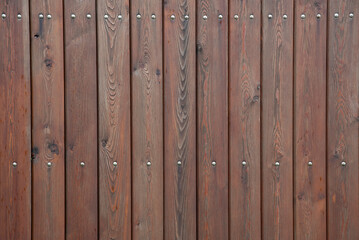 Brown wooden background of linear planks