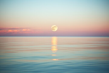 full moon rising over a calm sea