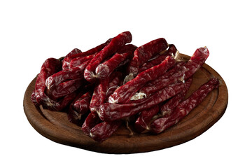 Fototapeta premium Smoked sausages (cabanos) on a wooden board close-up.