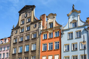 Fototapeta na wymiar Beautiful architecture of the old town in Gdansk. Close-up with details. Bright facades of buildings. View of the Old Town. A walk through the city on a sunny summer day