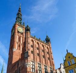 Beautiful architecture of the old town in Gdansk with city hall and Artus court, Poland. A walk through the city on a sunny summer day