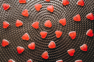 Candies in the form of a red heart on the table. Composition for Valentine's Day February 14th. Valentine Card Holiday concept In Romantic Background.