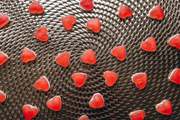 Candies in the form of a red heart on the table. Composition for Valentine's Day February 14th. Valentine Card Holiday concept In Romantic Background.