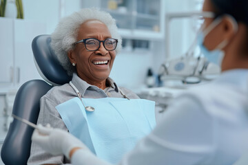 Fototapeta premium Senior African American woman talking to her dentist during appointment at dental clinic