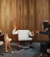Two people sitting with invisible third person, looks as chair with hands who want to tell on retro...