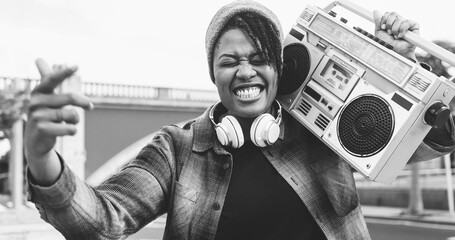African american woman singing underground music holding boombox vintage stereo - Urban lifestyle...