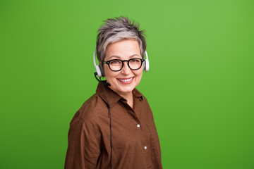 Photo of pleasant cheerful woman with short hairstyle wear brown shirt in headset consultating...