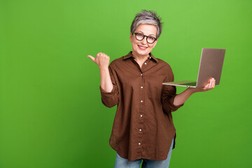 Photo of nice woman with gray hair wear shirt in glasses hold laptop indicating at eshop empty...