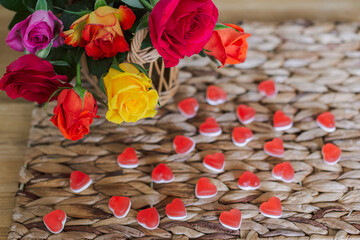 Colorful bouquet of flowers on the table and sweets in the shape of a heart. Composition for...